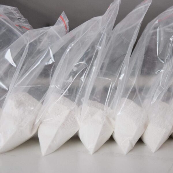 Buy fentanyl powder online, sealed in a laboratory sample container, labeled with hazard and controlled substance warnings.