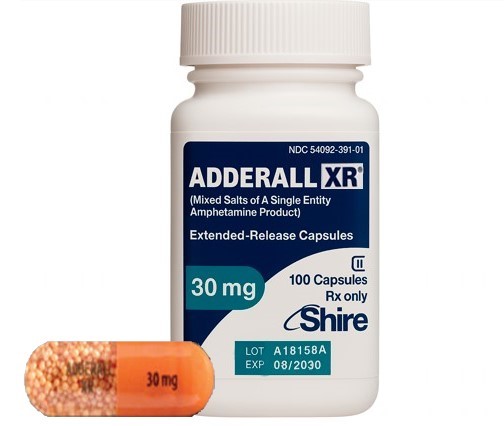 Adderall XR capsules in various strengths, with orange and blue color combinations, displayed on a clean surface.