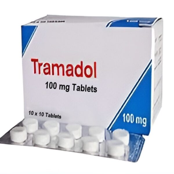 A close-up of white Tramadol tablets scattered near a prescription bottle on a white surface.