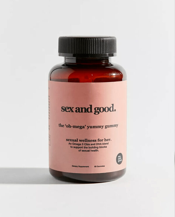 A bottle of "Oh-Mega Yummy Gummy" supplements, labeled for sexual health and energy, with colorful gummies spilling out.